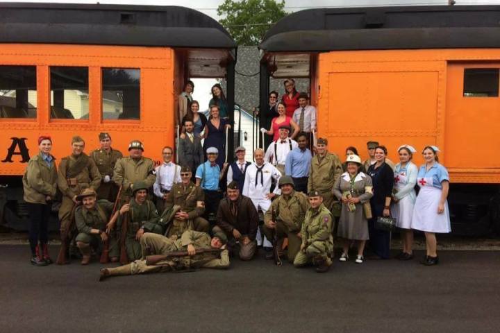 a group of people standing in front of a train