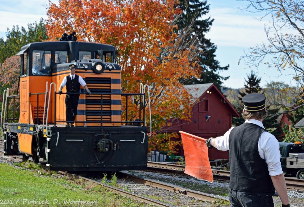 a man standing next to a train