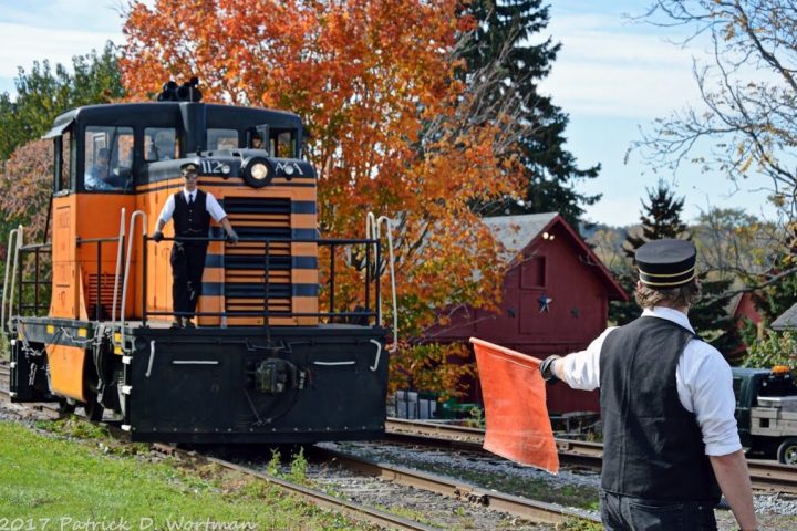 a man standing next to a train